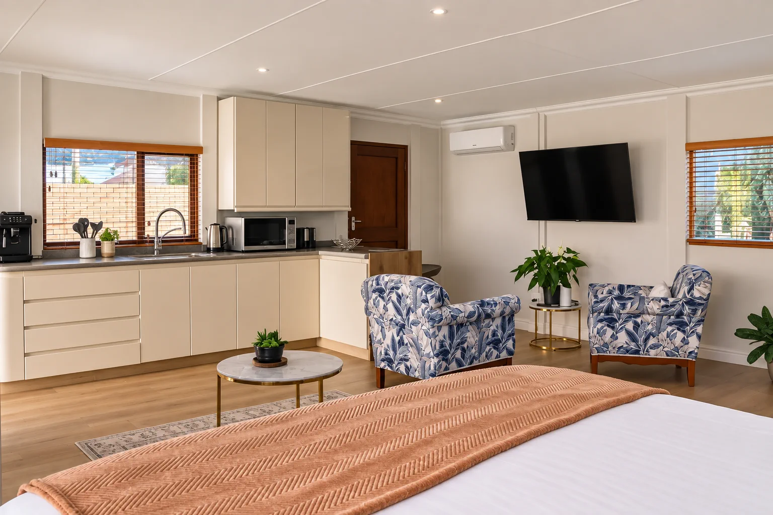 Beach Studio, Kitchenette, seating and Smart TV from the bed